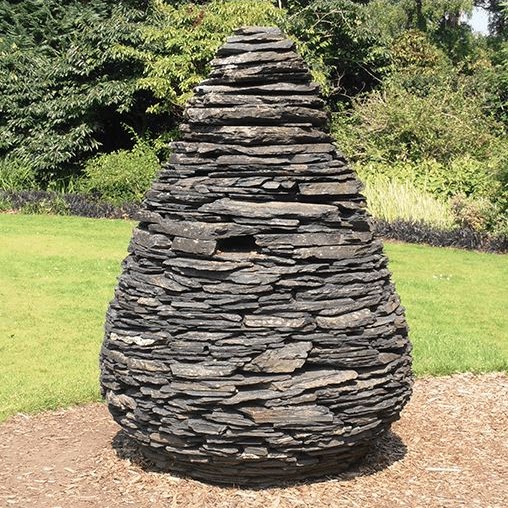A sculpture made of layered slate to look like a pine-cone