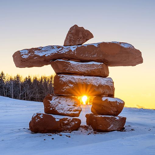 An inukshuk, a stack of rocks formed by the Inuits in a snowy background