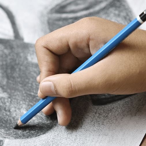 A hand shading a drawing with a pencil