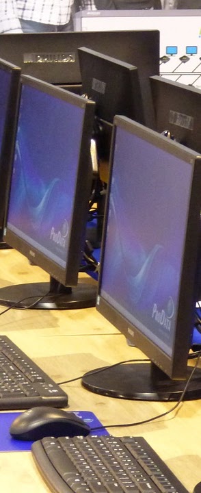 Photo of two monitors and keyboards