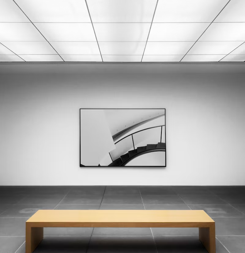A black and white artwork hung in a gallery
