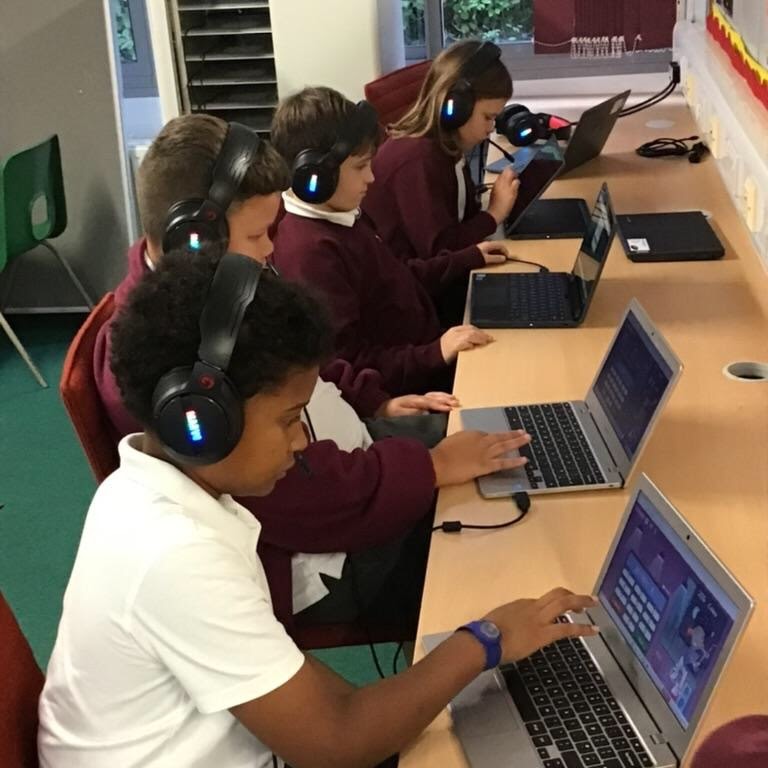 A group of children using laptops