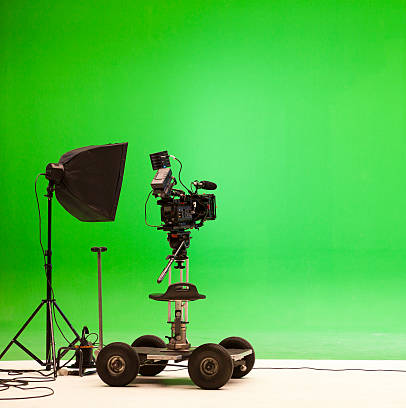 A green screen, camera and lighting equipment