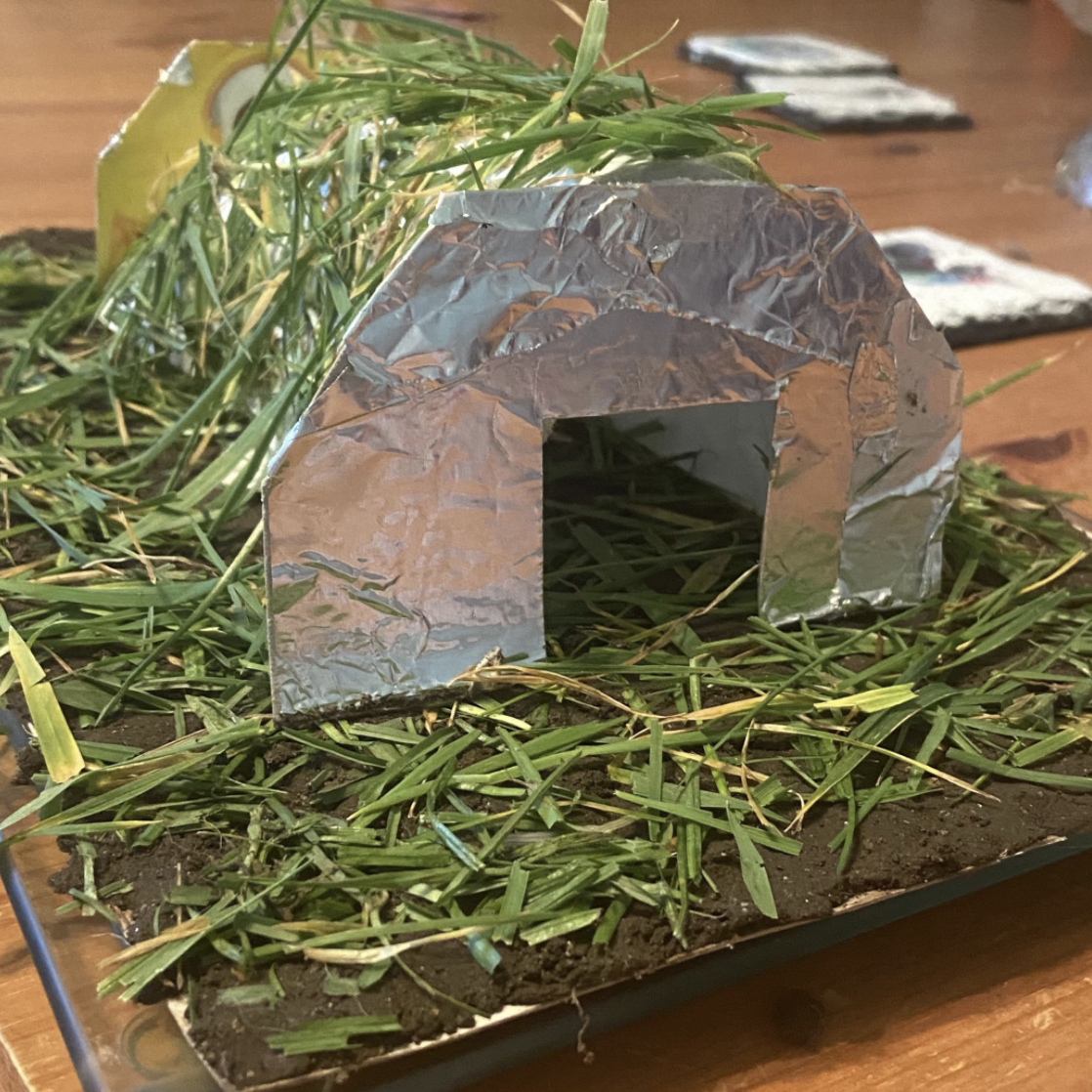 A model of a structure covered in grass