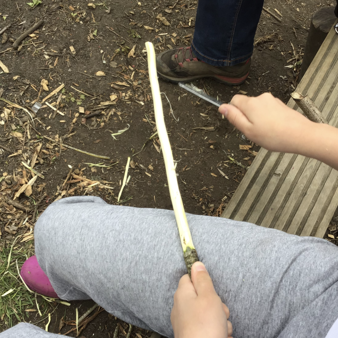 A child whittling a stick