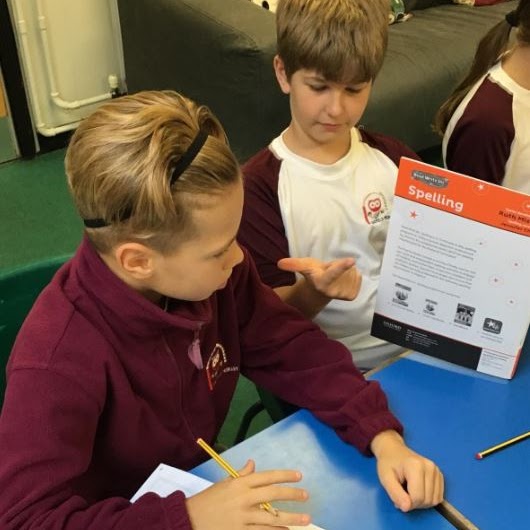 Two boys working together on their spellings