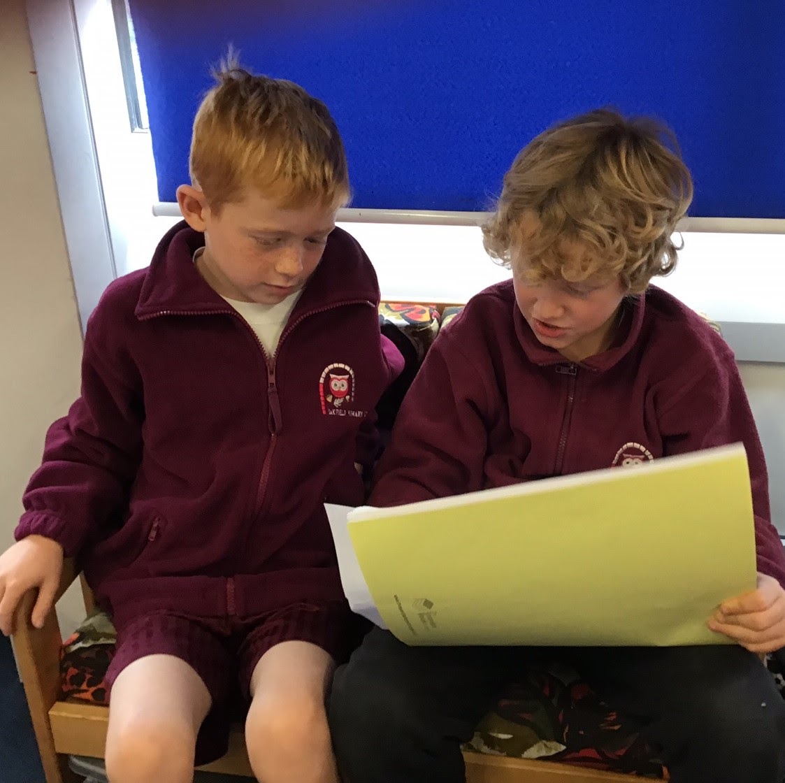 Two boys reading together