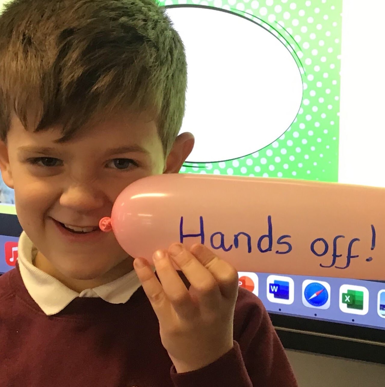 A boy holding a balloon with writing on it