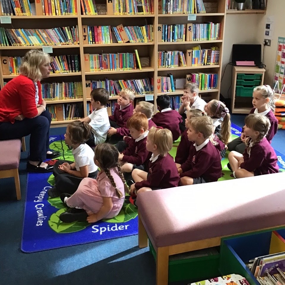 Mrs Lailey talking to a group of children in the library