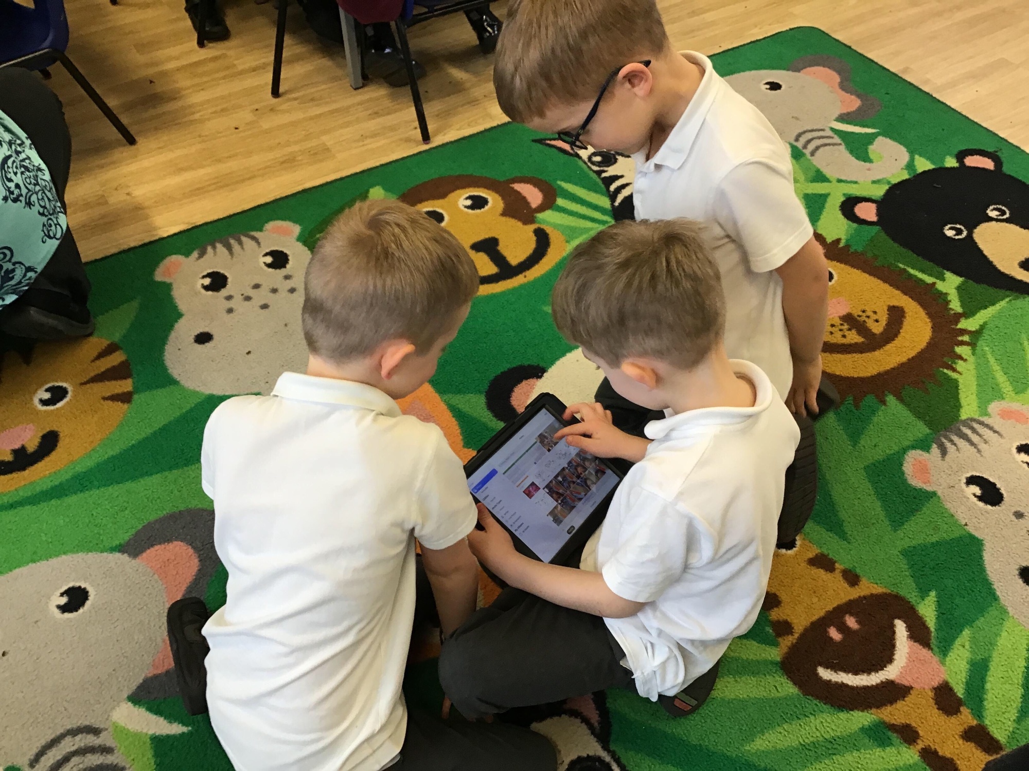 Children working together on a tablet