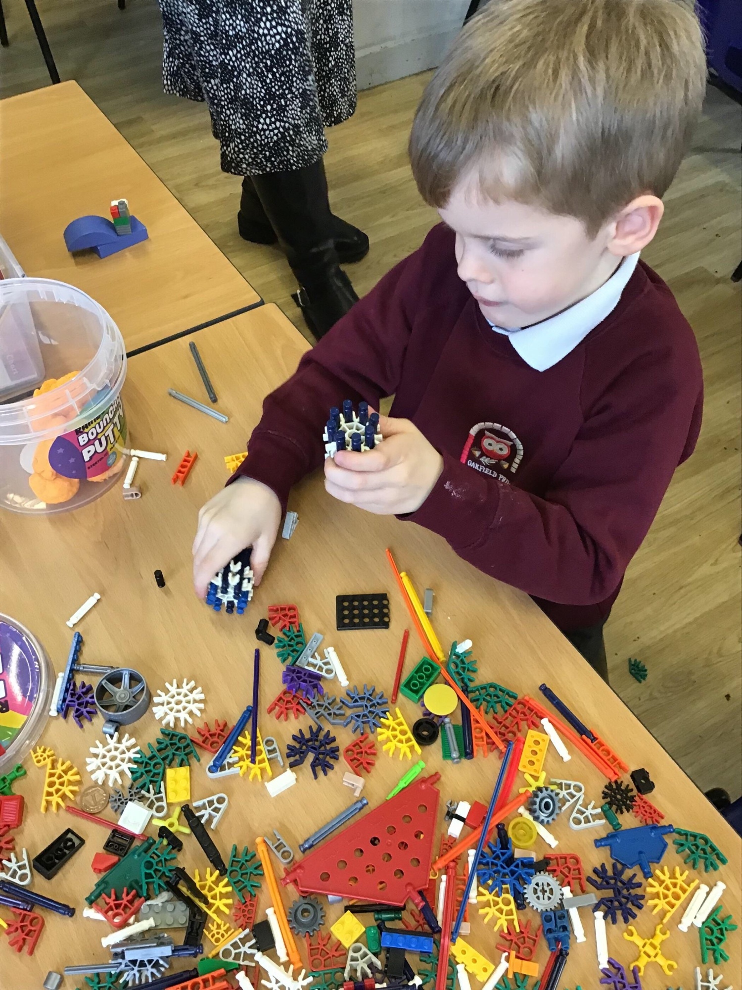 A boy building a Meccano model
