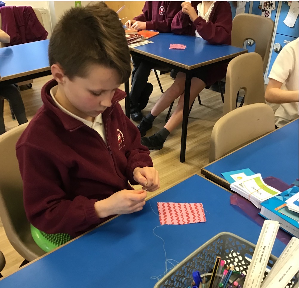 A boy sewing