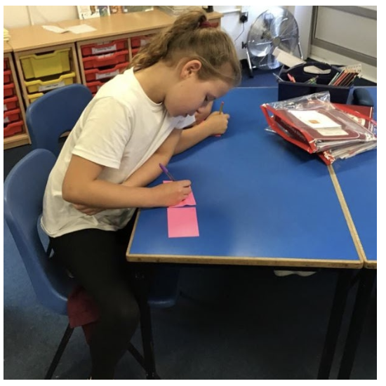 A child writing on cards